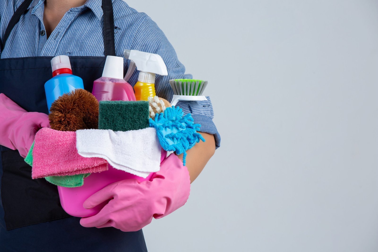 woman is holding cleaning product gloves rags basin white wall scaled 1.jpg